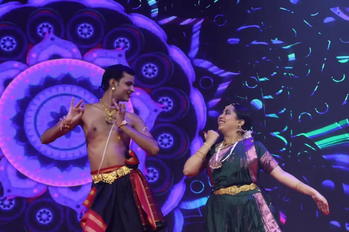 SAP Bandhan 2025 — duo performance on purple LED stage
